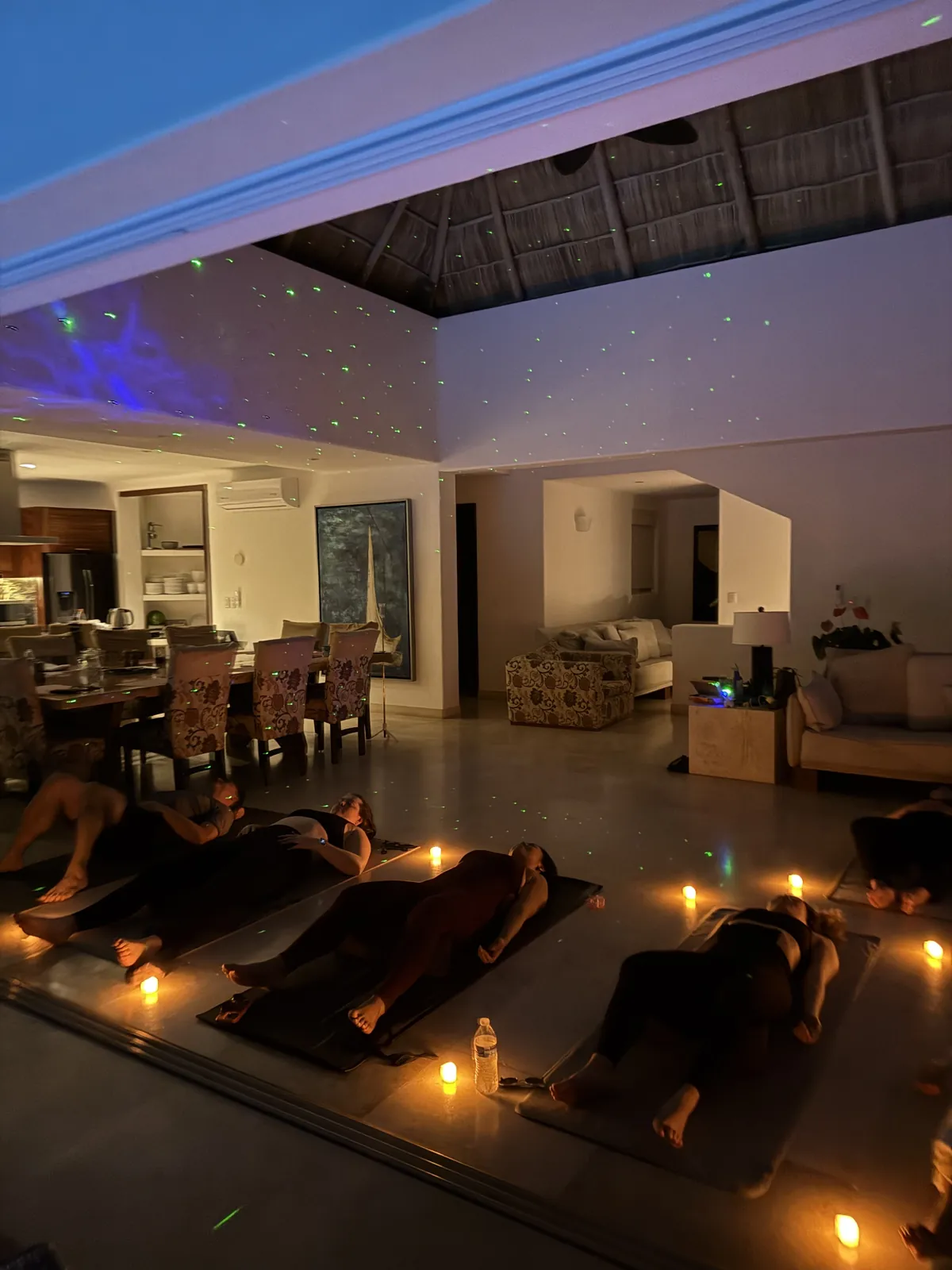 Candlelit sound bath with guests resting on mats