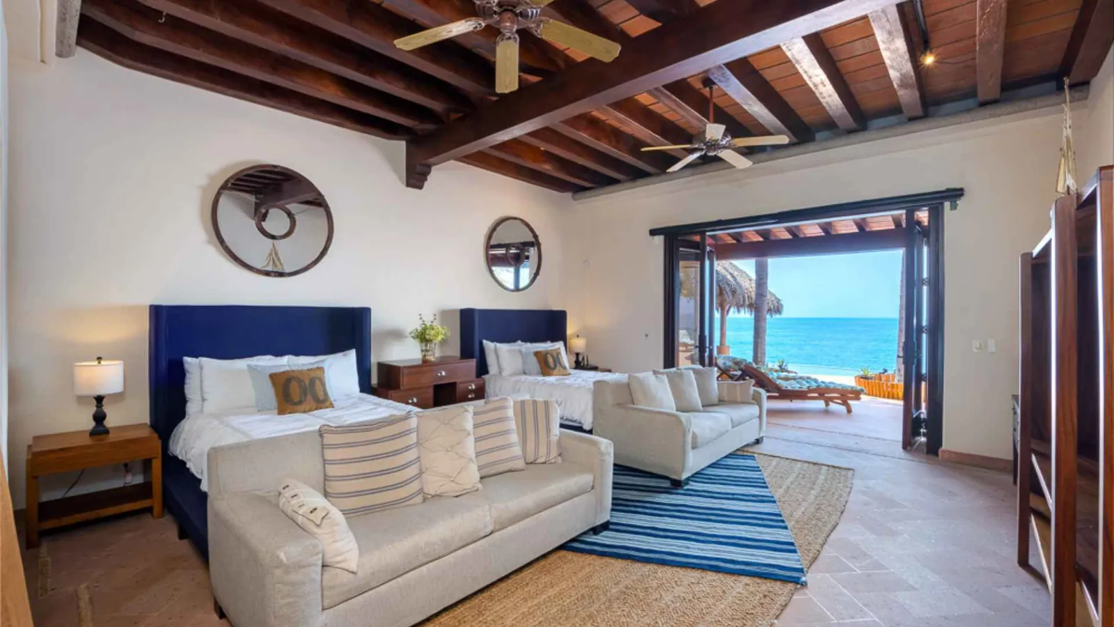 Shared double room with two beds opening onto the ocean