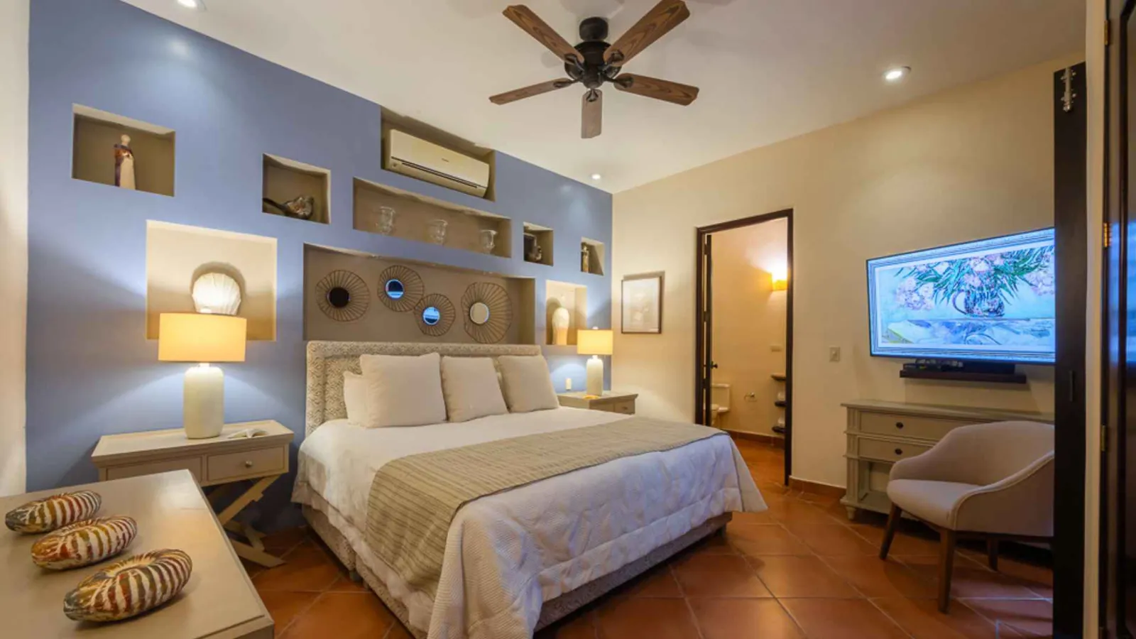 Private suite with a king bed and soft blue feature wall