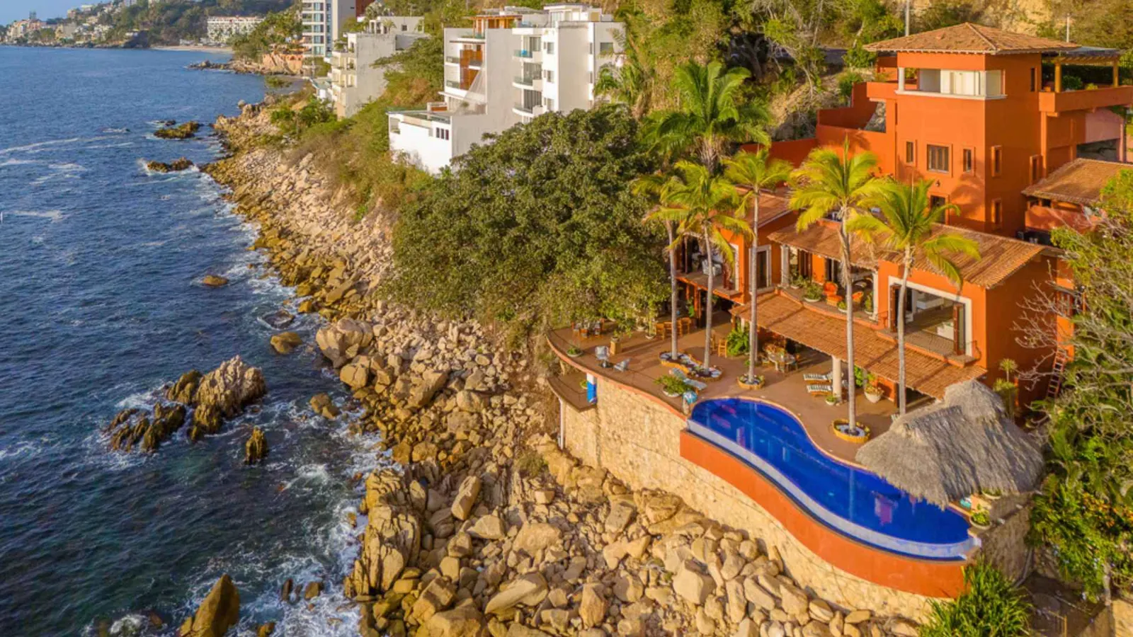 Aerial view of the oceanfront villa on the rocks with its infinity pool