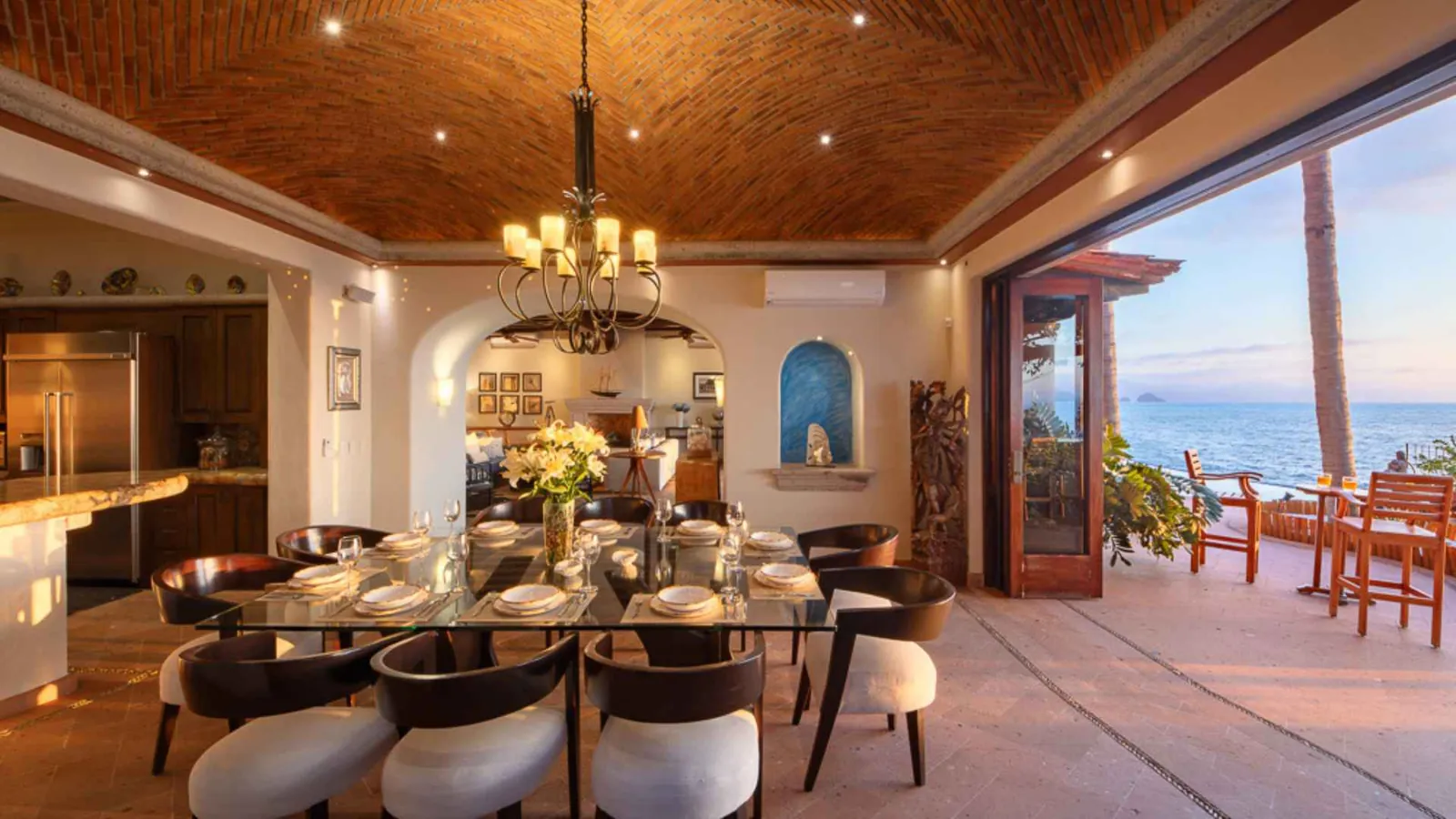 Open-air dining room and kitchen opening onto the ocean