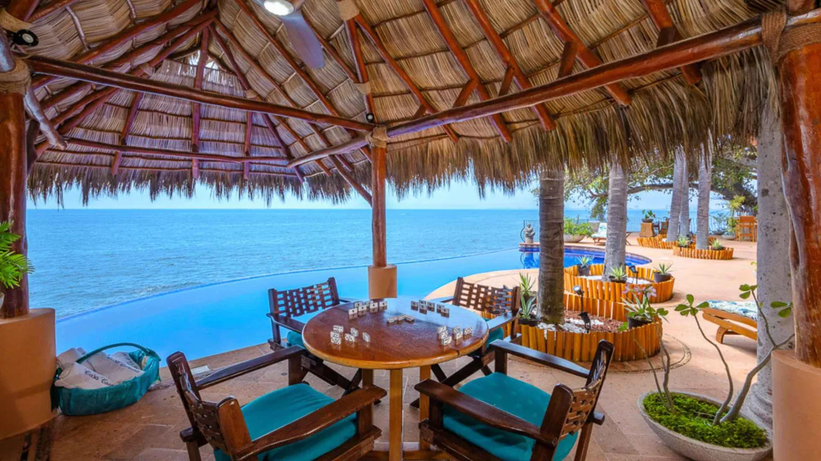 Palapa lounge with dining table and ocean view